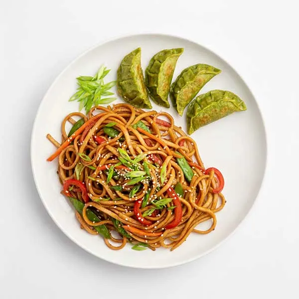 Wok-tossed lo mein and green dumplings
